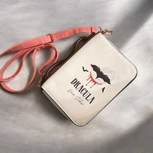 Dracula Bat Graphic Crossbody Bag in Cream with Pink Strap